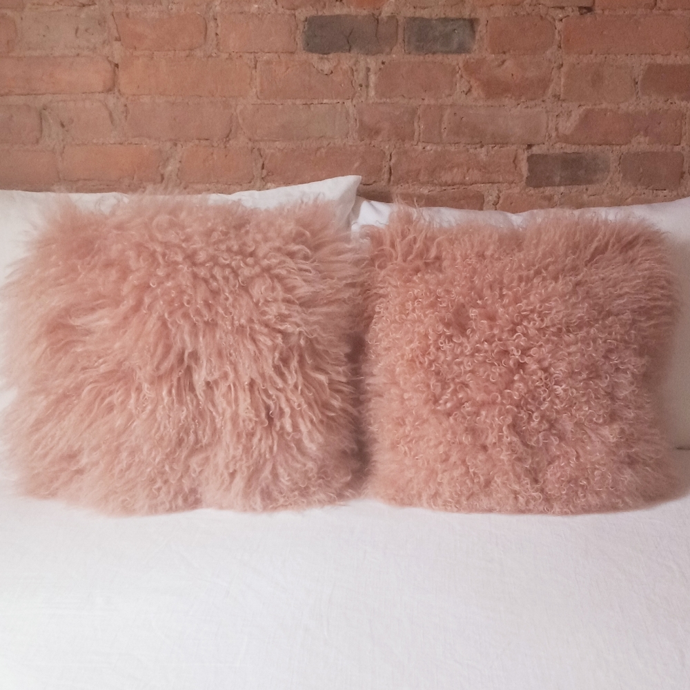 Pair of West Elm pink Mongolian lambskin pillows, inserts incl. Color “Rosette”